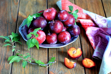 Summer plums on brown background - rustic style