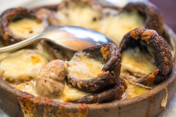 Stuffed mushrooms with cheese on the pot, Georgian cuisene