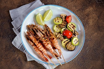 Grilled vegetables and prawns (shrimps) on bamboo skewers. Healthy food.