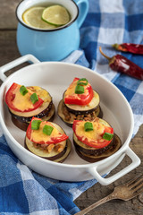 Slices of eggplant baked with minced meat, tomatoes and cheese.
