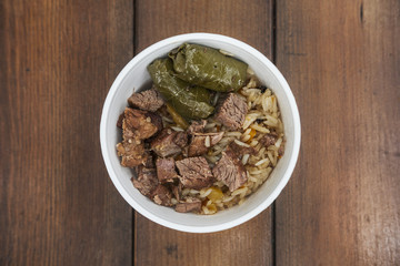 Soft focus photo of dolma and fried meat in take away plate