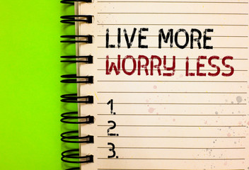 Word writing text Live More Worry Less. Business concept for Have a good attitude motivation be careless enjoy life Written black and red text and number on white notepad green background.