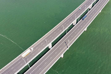 Aerial View of Bridge Over The Reservoir and Vehicles