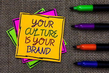 Text sign showing Your Culture Is Your Brand. Conceptual photo Knowledge Experiences are a presentation card Written on some colorful sticky note 4 pens laid in rank on jute base.