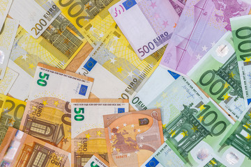 Euro banknotes as background on wooden desk