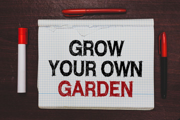 Handwriting text writing Grow Your Own Garden. Concept meaning Organic Gardening collect personal vegetables fruits Written black, red words notepad on brown stage white highlighter red pens.