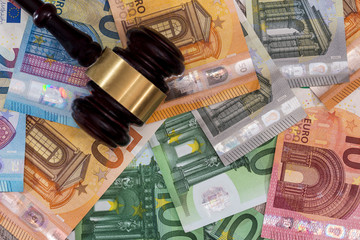 Judge's gavel on euro banknotes close up
