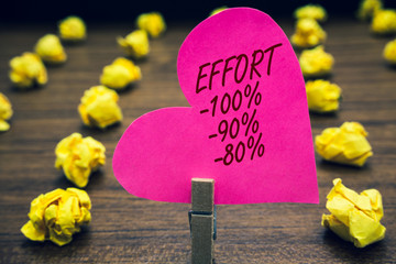 Conceptual hand writing showing Effort 100 90 80. Business photo text Level of determination discipline motivation Paperclip hold pink written heart woody floor with yellow lobs.