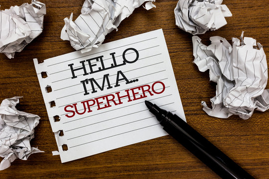 Text sign showing Hello I am A ... Superhero. Conceptual photo Special powers Cartoon character Customs strenght Paper lumps laid randomly around white notepad touch black pen on woody floor.