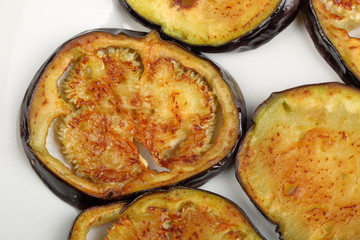 Sliced roasted eggplants in a white plate