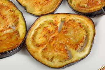 Sliced roasted eggplants in a white plate