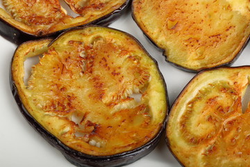 Sliced roasted eggplants in a white plate