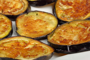 Sliced roasted eggplants in a white plate