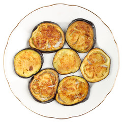 Sliced roasted eggplants in a porcelain plate isolated on a white background