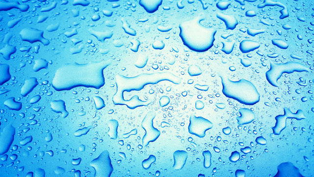 Water Drops background on the Blue glossy surface, Rain droplets on blue texture for cosmetics, drink product.