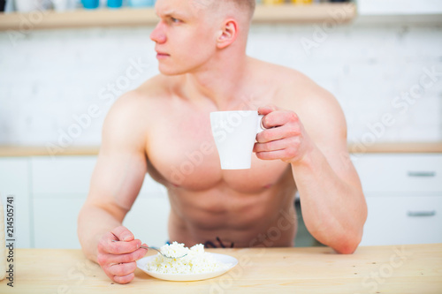 Muscular Man With A Naked Torso In The Kitchen With Milk And