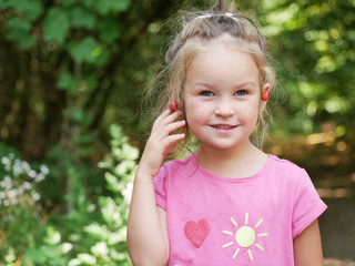 Little czech girl with red cherries on her ears.