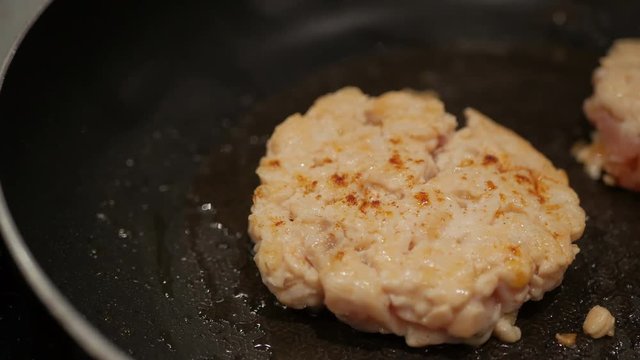 chef hand grill salmon mince burger on a pan.