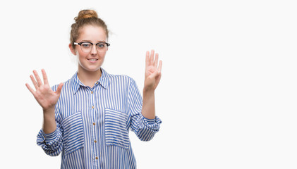 Young blonde business woman showing and pointing up with fingers number nine while smiling...