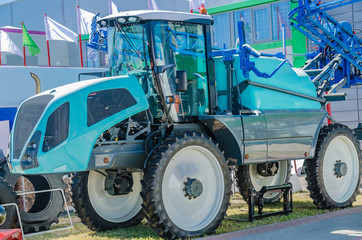 Fototapeta na wymiar modern tractor for agriculture on the farm with a powerful motor, the flagship of the modern agricultural industry