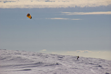 A kite surfing mountaineer on the slopes of Pe&ntilde;alara the highest mountain in the "Sierra de Guadarrama" in the middle of strong winds at Madrid, Spain