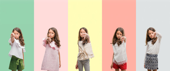 Collage of brunette hispanic girl wearing different outfits looking unhappy and angry showing rejection and negative with thumbs down gesture. Bad expression.