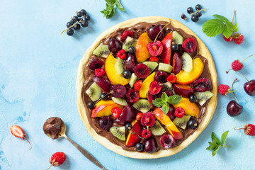 Delicious homemade Summer fruit berry pizza with chocolate paste. Vitamin dessert. Top view. Copy space.