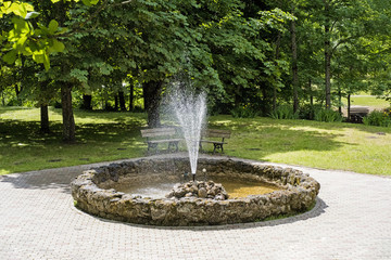 Round fountain in the middle of park.