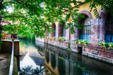 Beautiful mirror image of red walls of the market place in Colmar, France
