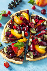 Delicious homemade Summer fruit berry pizza with chocolate paste. Vitamin dessert.