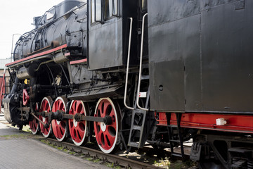 Old historical train. Metal locomotive construction