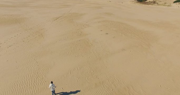 Aerial shot of person running on sand dunes Nags Head, North Carolina.