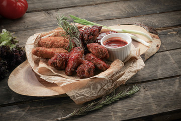 skewers of beef and chicken with sauce and pita bread on a wooden plate