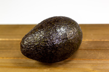 Avocado laying on the kitchen table waiting to be sliced up by the chef