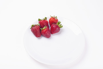 Fresh strawberries on a white plate