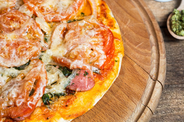 Colorful pizza with mozzarella cheese, chicken, sweet pepper and parsley close up top view. Italian...