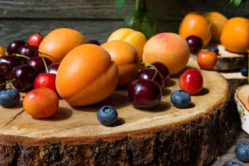 Fruits and berries on a stump.