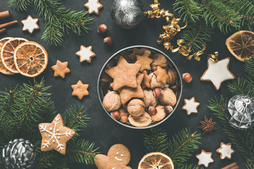 New Year or Christmas box with sweets Gingerbread cookies, gingerbread stars, dried orange rings and fir tree. Top view. Christmas flat lay composition - obrazy, fototapety, plakaty