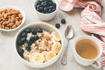 Healthy Tasty Breakfast Oatmeal Porridge Green Tea On The Table. Healthy Eating, Vegan, Vegetarian Breakfast Meal
