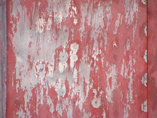 Rusty metal surface with rich and various texture painted in red grenadine