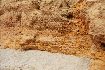 closeup of stone on the beach, sea coast with high hills, beautiful wild landscape