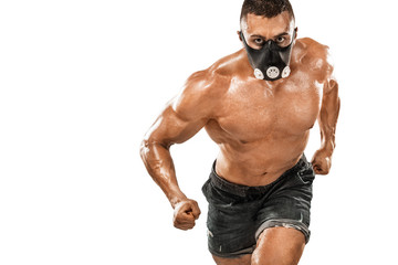 Fototapeta na wymiar Brutal strong muscular bodybuilder athletic man pumping up muscles in training mask on white background. Workout bodybuilding concept. Copy space for sport nutrition ads.