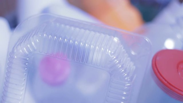 Closeup of workman holding rubbish bucket, takes riffraff for sorting, recycling