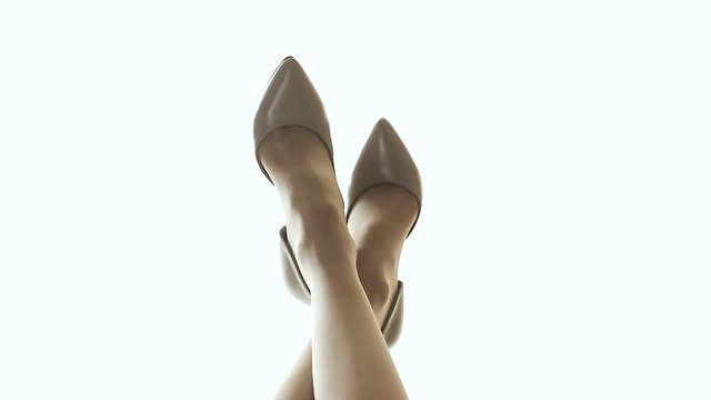 Young woman admiring smooth legs after shaving, looking at shoes of good quality
