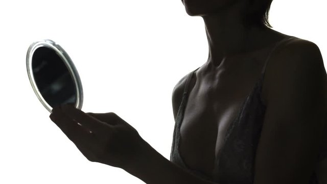 Pretty, middle-aged female view her body at mirror, caressing. Body woman's
