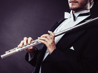 Elegantly dressed musician holding flute © anetlanda