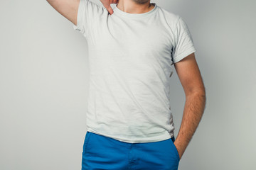 Shirt design, close up of young man in blank white tshirt front isolated. Mock up template for design print. Front view of a man in a white T-shirt.