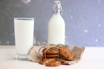 cookies with milk desert concept. cookies with bow and milk in bottle and glass