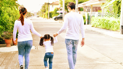 Concept Family.Parents and daughters go for a walk in the park.Family is doing holiday activities.