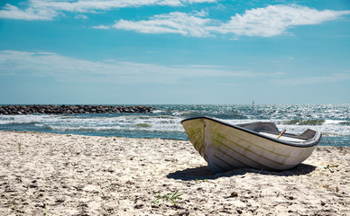 Boat on the sandy sunny beach. Stock photo.